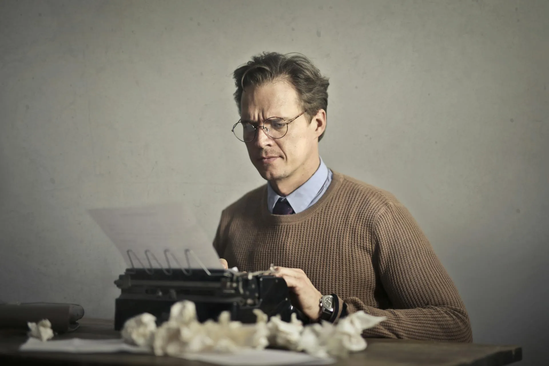 Man writing content on a typing machine