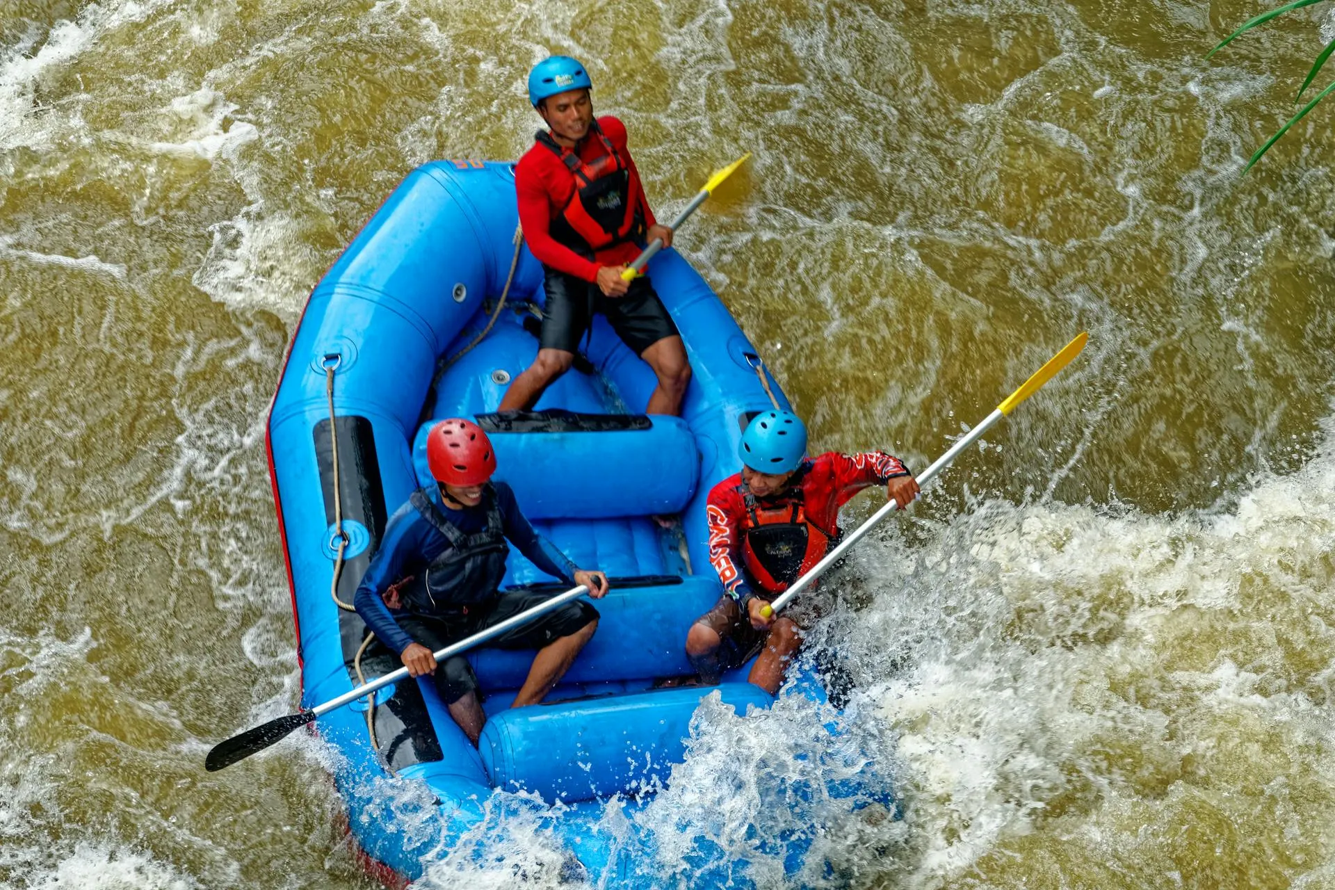 Men rafting in white water river