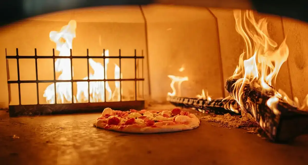Pizza baking in furnace